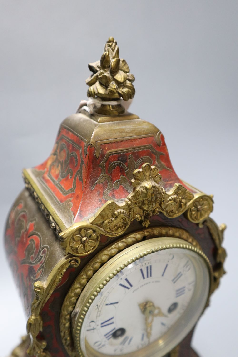 A 19th century French boullework and ormolu mounted mantel clock, dial signed by retailer Thos. Pearce and Sons, Paris, 31cm
